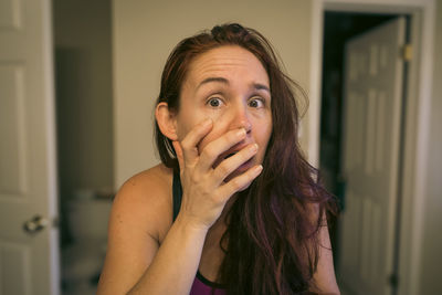 Worried woman in bathroom staring