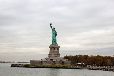 Statue of liberty against cloudy sky