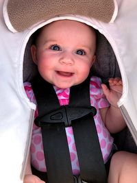 Portrait of smiling baby girl in carriage