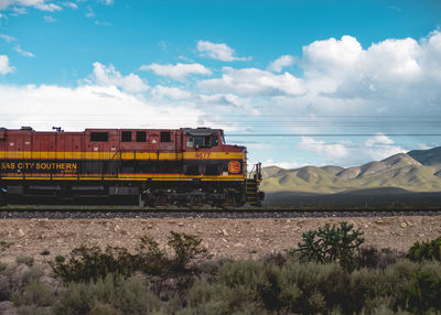 Railroad tracks against cloudy sky