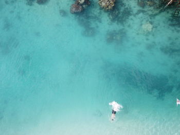 High angle view of people swimming in sea