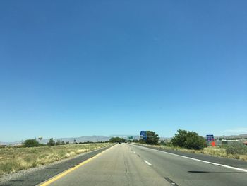 Empty road along trees