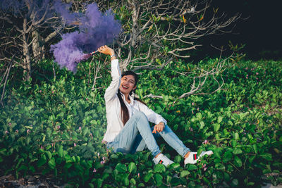 Portrait of smiling young woman with plants