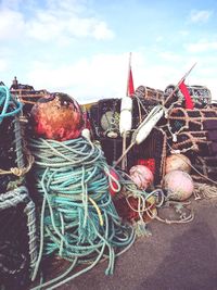 Close-up of fishing net against cloudy sky