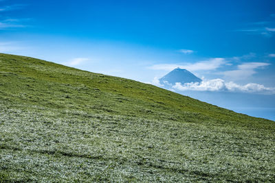 Scenic view of land against blue sky