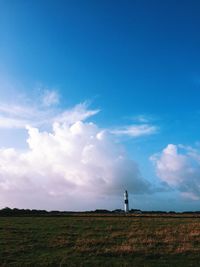 Man standing on field against sky