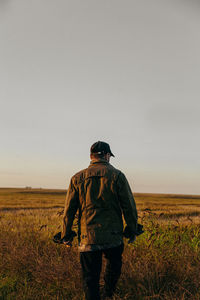 Portrait of a man in a field at sunset
