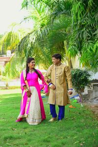 Full length of woman standing by pink tree