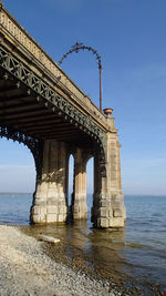 View of bridge over sea against clear sky