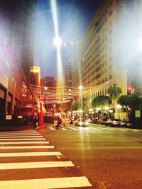 Illuminated city street at night