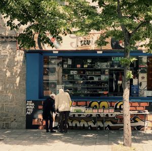 Rear view of woman sitting on street