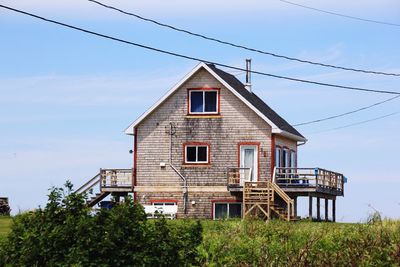 Exterior of abandoned built structure against blue sky