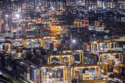 High angle view of illuminated cargo containers at commercial dock