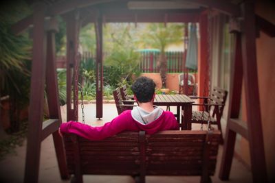 Rear view of man sitting on chair