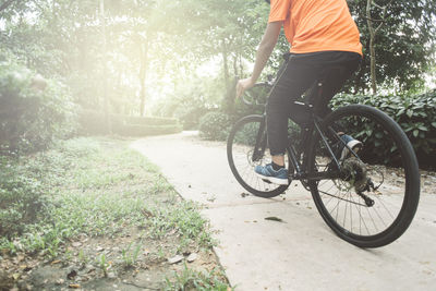 Man riding bicycle on road