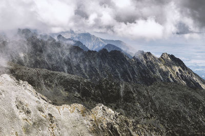 Scenic view of mountains against cloudy sky