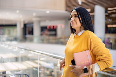 Woman standing in shopping mall