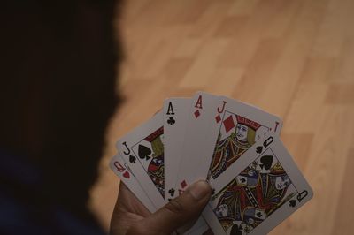 Cropped hand holding cards