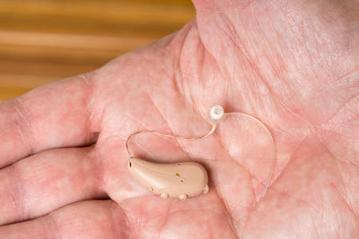 Close-up of hearing aid in hand