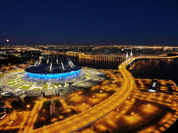 High angle view of city lit up at night