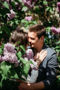 Spring love, dating, romance. happy loving couple kissing and hugging on blurred lilac background