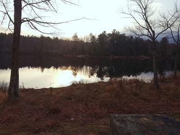 Scenic view of lake against sky at sunset