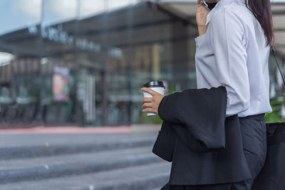 Close-up of woman holding mobile phone