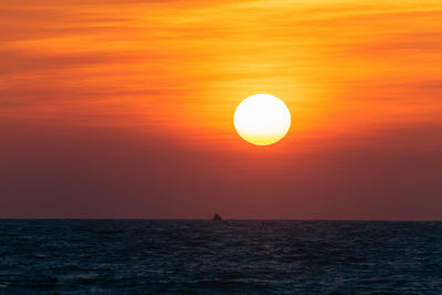 Scenic view of sea against orange sky