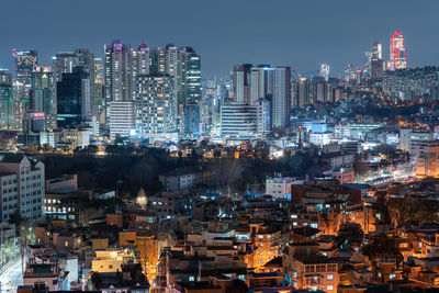 High angle view of illuminated buildings in city at night