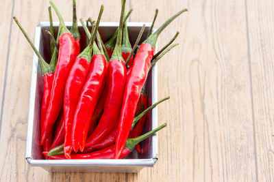 Close-up of red chili peppers on cutting board