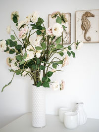 Close-up of white flowers in vase on table