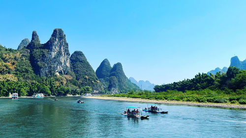 Scenic view of river against clear blue sky