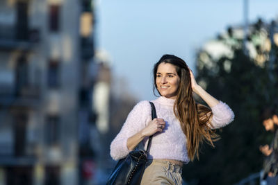 Woman looking away in city