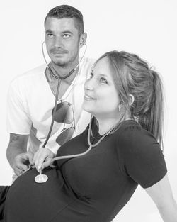 Portrait of young couple against white background