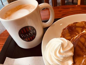 High angle view of cup and coffee on table