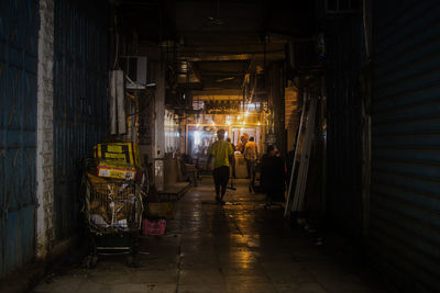 Man in illuminated corridor of building