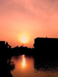 Reflection of buildings in water at sunset