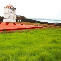 Lighthouse on grassy field