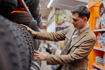 Man choosing tire at store