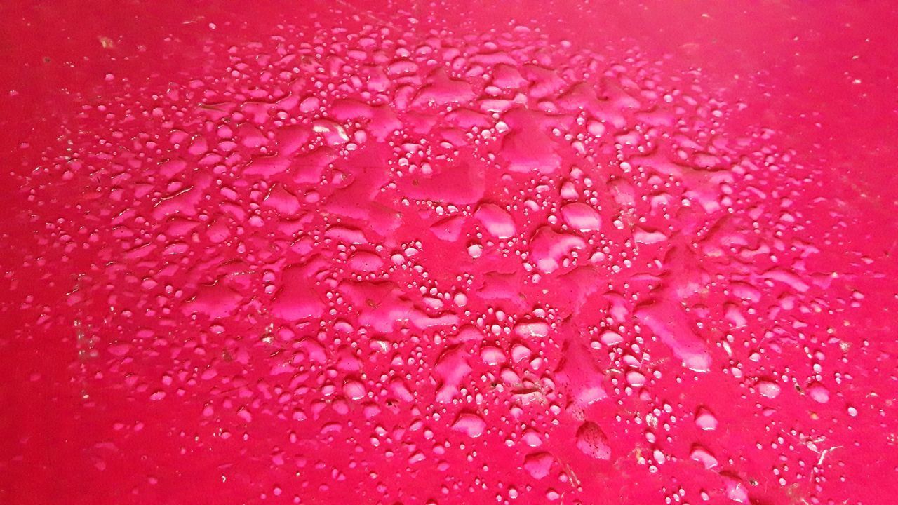 FULL FRAME SHOT OF WATER DROPS ON PINK BACKGROUND