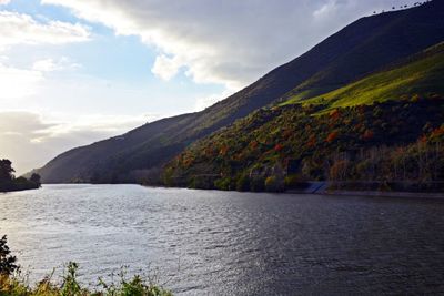 Scenic view of mountains against cloudy sky