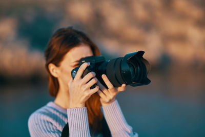 Portrait of woman photographing