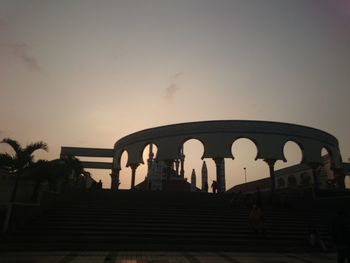 Low angle view of silhouette people against sky