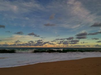 Scenic view of beach against sky during sunset