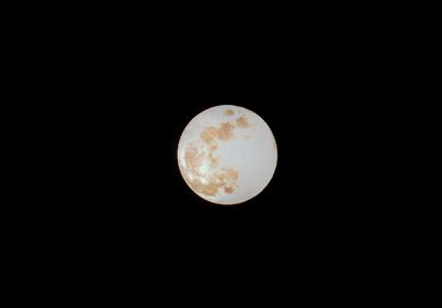 Low angle view of full moon against sky at night