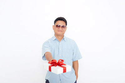 Portrait of a young man against white background