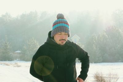 Portrait of smiling young man in snow