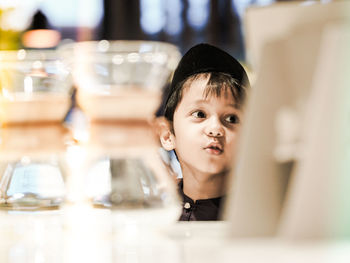 Portrait of boy looking away in restaurant