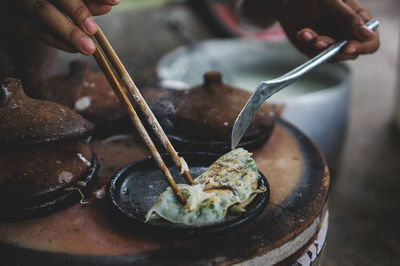 Cropped image of person preparing food