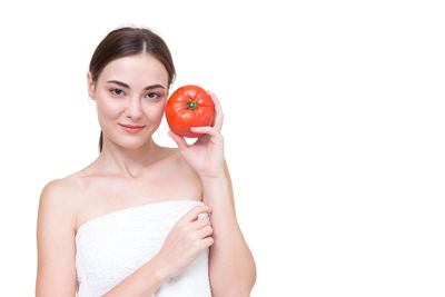 Portrait of a smiling young woman against white background